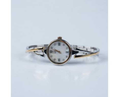 Swiss quartz watch with gold plated accents on stainless steel case and bangle style bracelet with a fold-over clasp. Mother 