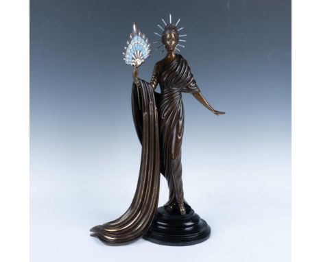 A striking limited edition bronze sculpture captures a beautiful woman in an elegant, flowing dress, gracefully holding a vib