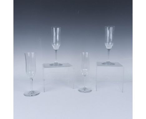 Crystal champagne flutes in the Capri pattern with intricate and slender design. Baccarat etched marking. Dimensions: 3"W x 7