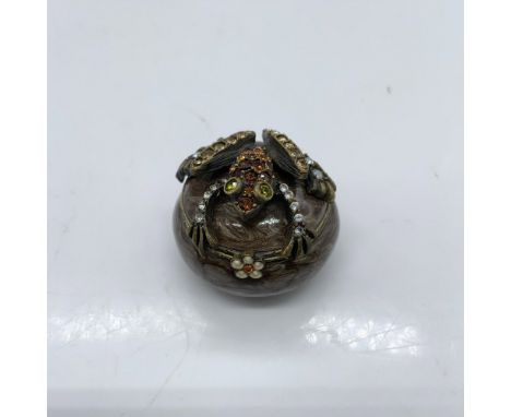 Beautiful trinket box decorated with enamel and colored crystals. Jay Strongwater stamp on the bottom. Dimensions: 1.25"dia. 