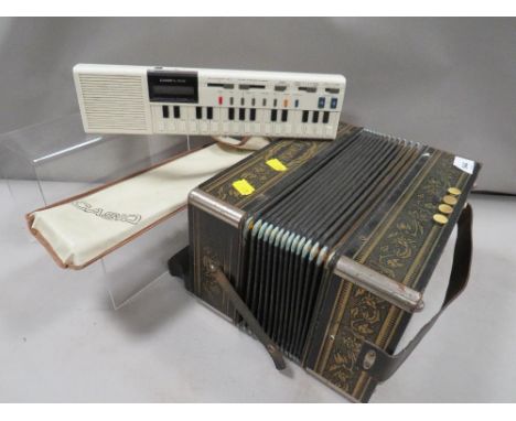 A Hohner squeeze box together with a Casio VL-Tone 