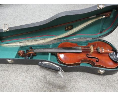A vintage leather covered wooden cased violin with bow 