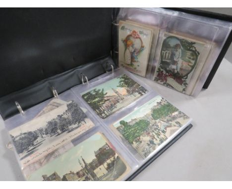 Two vintage postcard albums together with an antique family photograph album 