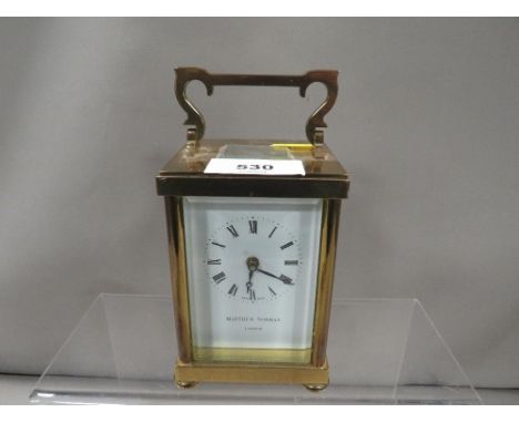 A small Matthew Norman carriage clock and key 