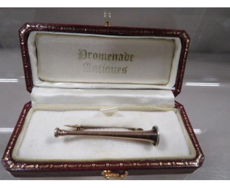 A Victorian hunting horn equestrian brooch marked 9ct 