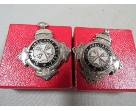 Two silver and enamel St John Ambulance pocket watch chain medals in original boxes 