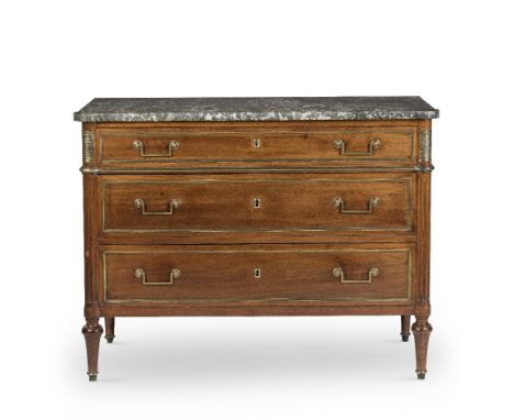 A Directoire mahogany and gilt brass mounted commode The grey marble rectangular top above three drawers flanked by fluted ro