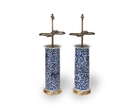 A pair of blue and white porcelain vases, later adapted to lampsWith adjustable brass light fittings and moulded gilt bases, 