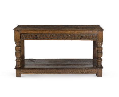 A late 17th century and later oak side tableThe later rectangular plank top above a single long frieze drawer on turned front