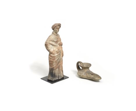 After the Antique, a Greek terracotta female figure Together with an Islamic style terracotta oil lamp, 10cm wide, 5.5cm deep