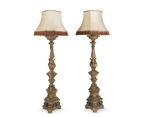A large pair of Italian 18th century carved giltwood and gesso torchères or candle standsWith carved acanthus and moulded tri