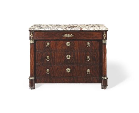 A Charles X mahogany and gilt metal mounted commode The rectangular marble top above four drawers flanked by columns of turne
