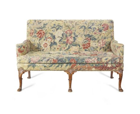 A George I walnut framed sofa The gros point and petit point upholstered rectangular back above a square seat within out-scro