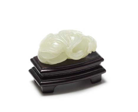 A pale green jade carving of a pomegranate 19th / 20th century Naturalistically modelled, with hardwood stand, 5cm wide (2). 