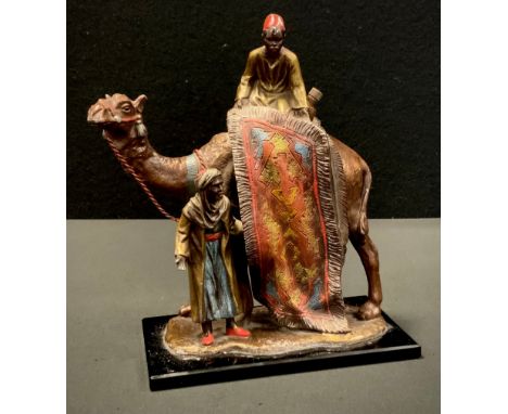 An Austrian rug seller and camel table strike lighter, manner of Franz Bergman, with patinated and cold painted finish depict