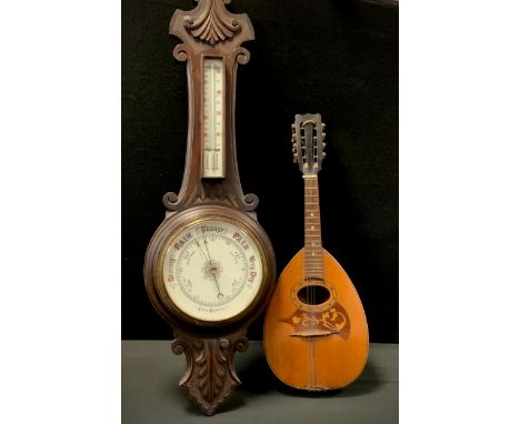 20th century wooden carved barometer,92cm high; an inlaid Neapolitan bow back mandolin, 61 cm long (2) 