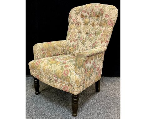 A 20th century button-back fireside armchair, 93cm high x 64cm wide x 68cm deep. 