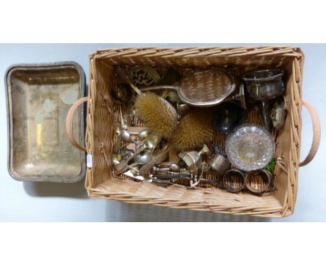 A basket of silver and plateware, includes entree dish, silver enamel backed brush set, silver and other cutlery, napkin ring