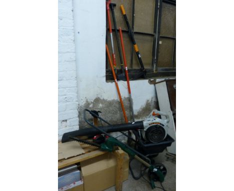 A petrol powered leaf blower, together with a selection of garden tools, fertilizer spreader and battery powered telescopic t