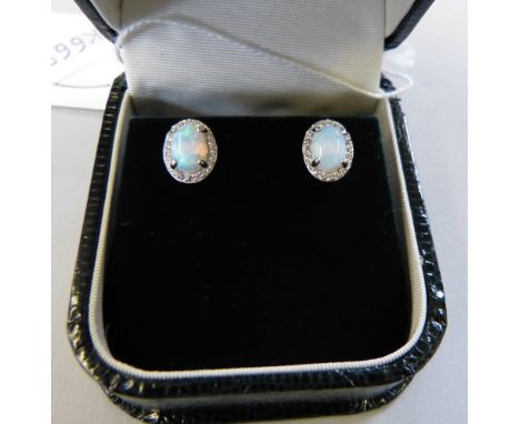 A sterling silver pair of opal and cubic zirconia earrings 