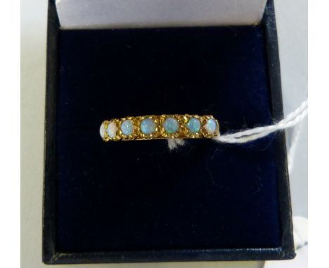 A silver/gilt seven stone opal ring