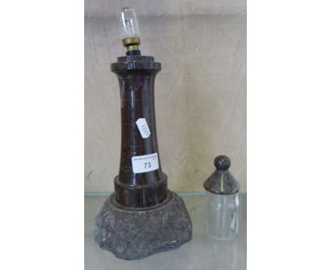 A polished stone table lamp, in the form of a lighthouse