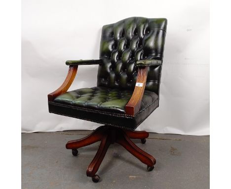 A mahogany and green leather button back office chairStructurally sound, wear and holes to the leather