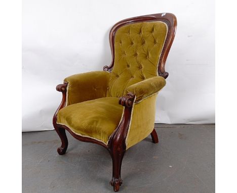 A Victorian mahogany framed button back armchairRepairs to the frame, variation of colour, wear to the upholstery