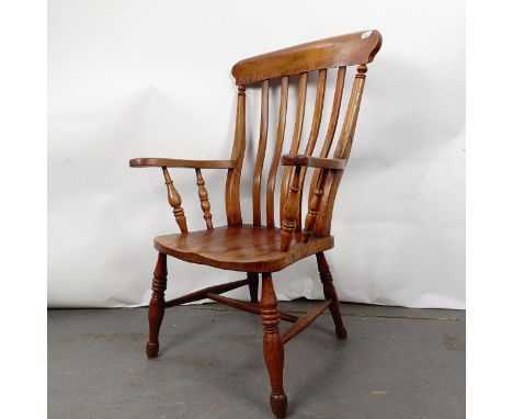 A Victorian elm and beech stick back kitchen armchairStructurally sound, variation of colour, general wear