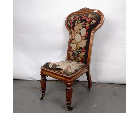 A 19th century Continental nursing chair, with a carved top rail, with a tapestry back and seat, 105 cm highFrame loose at jo