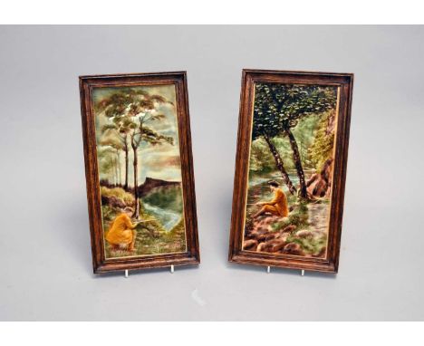 A pair of late 19th/early 20th century rectangular tiles of a hunter and a fisherman seated in a wooded area by a lake, frame