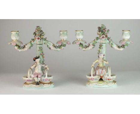 A pair of German porcelain figural sweetmeat candelabra, probably Dresdenlate 19th centurymodelled as male and female figures