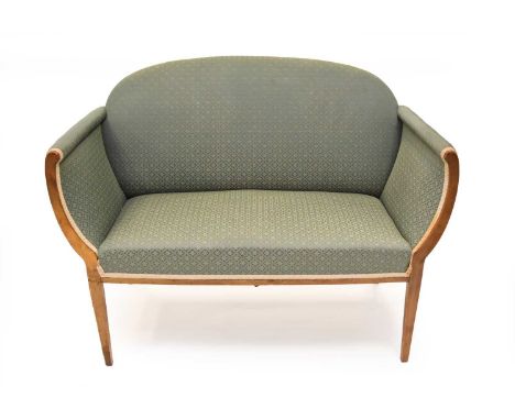A circa 1900 upholstered mahogany sofa, the padded back, seat and arms in a green brocade trellis pattern fabric, raised on t