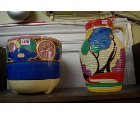 Two Clarice Cliff items, comprising a 'Blue Autumn' Isis jug, 29cm high; and a 'Sliced Fruit' pattern large jardiniere, 21.5c