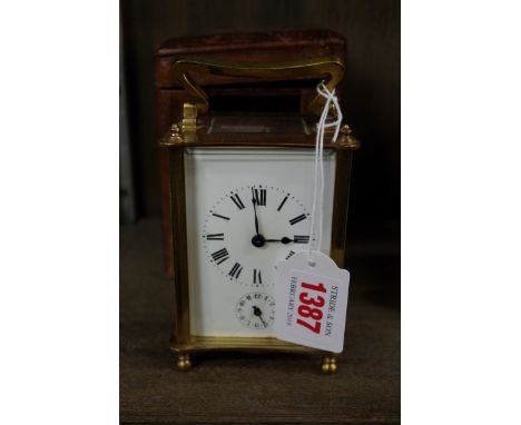 A old brass carriage clock, with alarm and bell strike, height including handle 14cm, with leather travel case and winding ke