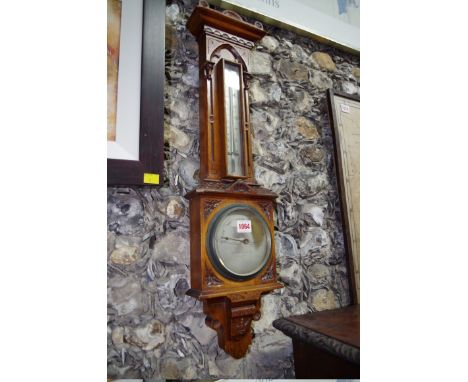 An oak aneroid banjo barometer, the silvered dial inscribed 'Negretti &amp; Zambra, London, 7204', 71.5cm high.&nbsp; 