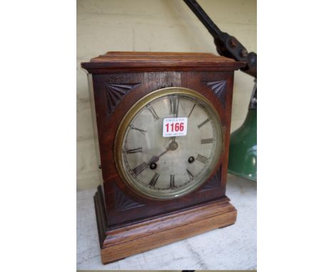 An oak mantel clock, 26.5cm high. 