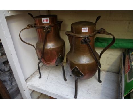 Two Continental copper and steel tripod jugs, height to thumbpiece of largest 39.5cm. 