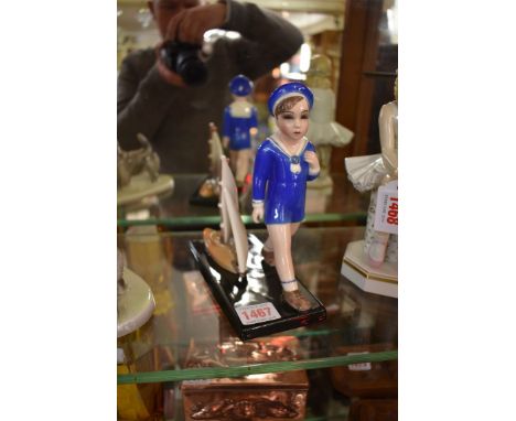 A Goldscheider figure of boy with a toy boat,&nbsp;No 7028, boat 18cm. 