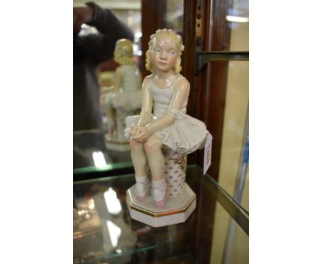An early Royal Copenhagen porcelain figure of a seated ballerina girl,&nbsp;No 4073, 21.5cm high. 