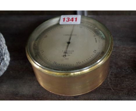 A brass aneroid barometer, the silvered dial inscribed 'T Wheeler, London, B32, 1937', with broad arrow stamped to the revers