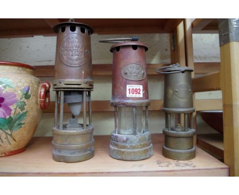 A Hailwoods miner's type lamp no.1402; together with two other miners' type lamps. 