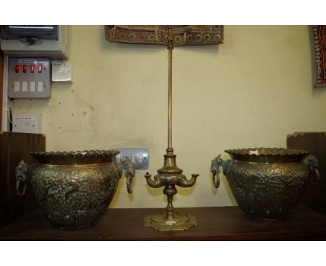 A pair of Persian brass twin handled jardinieres, 17.5cm high; together with an Eastern brass three branch oil lamp, 54cm hig