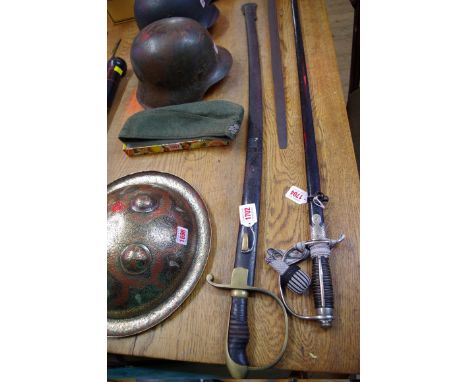 An antique cavalry sabre,&nbsp;with 85cm fullered blade, and having brass guard, in black painted steel scabbard. 