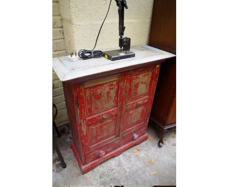 A painted hardwood small cabinet, with a pair of fielded panel doors above an apron drawer, 73cm wide. 