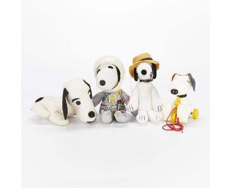 Group of four Peanuts dolls and toys depicting either Snoopy or Spike. One Snoopy doll dressed as an astronaut with a plastic