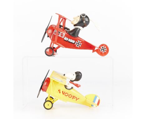 Group of two plastic toys depicting the Red Baron and Snoopy as the Flying Ace in their biplanes. Produced by Mattel.(Yellow)