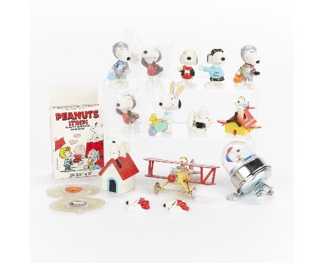 Group of 16 small toys depicting Snoopy. One Starship Snoopy bicycle bell, one Peanuts plastic bandages, one metal toy of Fly