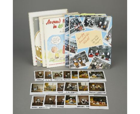 Group of six books and 19 Polaroid photos depicting Snoopy around the world. Including:Nineteen Polaroid photographs showing 