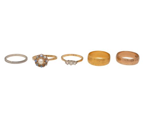 Five rings:  a 22ct yellow gold wedding band; a brilliant-cut diamond three stone ring, the shank stamped '18CT'; a 9ct yello